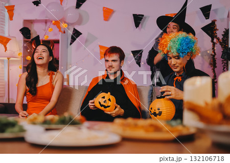 Joyful office Halloween party with coworkers in costumes, celebrating with drinks and laughter, fostering teamwork and festive spirit 132106718