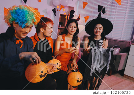 Joyful office Halloween party with coworkers in costumes, celebrating with drinks and laughter, fostering teamwork and festive spirit 132106726