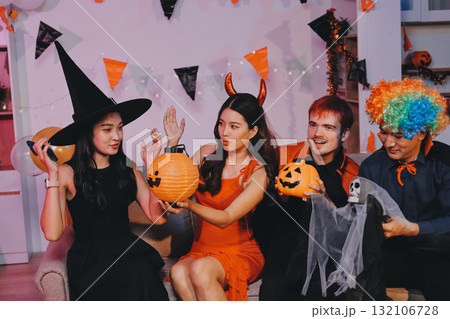 Joyful office Halloween party with coworkers in costumes, celebrating with drinks and laughter, fostering teamwork and festive spirit 132106728