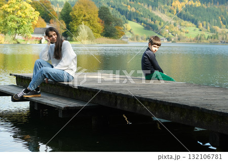 Mother and Son Sitting Apart. Parenting Conflict, Misunderstanding and Emotional Distance Mother and Son Sitting Apart. Parenting Conflict, Misunderstanding and Emotional Distance 132106781