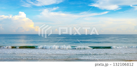 Tranquil Seascape With Gentle Waves Rolling Onto Sandy Beach Under Clear Blue Sky Horizontal Tranquil Seascape With Gentle Waves Rolling Onto Sandy Beach Under Clear Blue Sky Horizontal 132106812