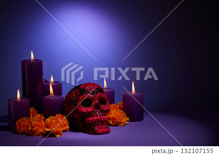 Dia de Muertos Ambiance. Vibrant purple candles and colorful skull surrounded by marigold flowers, Dia de Muertos Ambiance. Vibrant purple candles and colorful skull surrounded by marigold flowers, 132107155