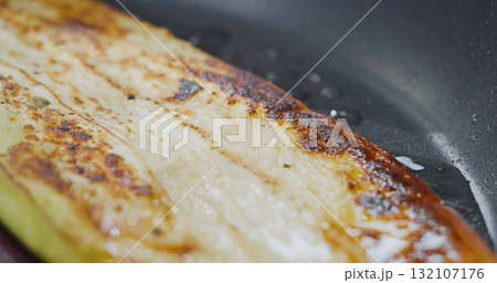 Macro Footage Fried Sliced Eggplant in Pan. Delicious Vegetables Close Up. Macro Footage Fried Sliced Eggplant in Pan. Delicious Vegetables Close Up. 132107176