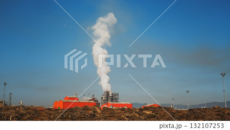 Industrial Factory Pollutes. Smoke on blue sky background. 132107253