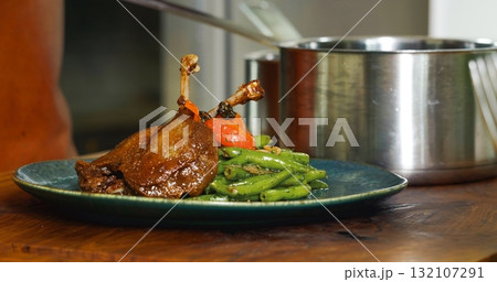 Appetizing Duck Meal Fried Tomato Decorated Close Up Details of Cooking. Appetizing Duck Meal Fried Tomato Decorated Close Up Details of Cooking. 132107291