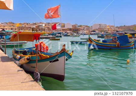 Colorful luzzu boat on Marsaxlokk promenade, Malta 132107970