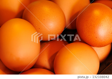 Fresh brown eggs gathered in a rustic basket, ready for baking and cooking in a cozy kitchen 132108042
