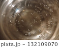 An abstract, high-angle macro close-up shot looking down into a glass containing Champagne or sparkling wine 132109070
