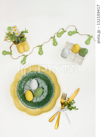 Easter celebration concept. Top view vertical green yellow plate eggs, isolated background, banner Easter celebration concept. Top view vertical green yellow plate eggs, isolated background, banner 132109417