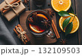 Overhead Mulled Wine with Orange Slices and Cinnamon Sticks on Wooden Table Top View 132109503