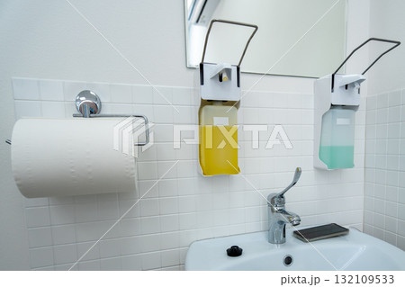Hygiene restroom soap dispenser in modern public washroom with essential amenities 132109533