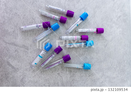 Blood tubes, medical, laboratory. Empty blood collection tubes with colorful caps scattered on a light background with copy space, useful for diagnostics. Blood tubes, medical, laboratory. Empty blood collection tubes with colorful caps scattered on a light background with copy space, useful for diagnostics. 132109534