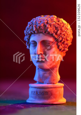Close-Up of Plaster Hermes Bust with Colorful Neon Backdrop Close-Up of Plaster Hermes Bust with Colorful Neon Backdrop 132109626