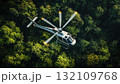 Aerial View of a Helicopter Flying over a Dense Green Forest in Daylight 132109768