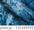 Aerial View of a Helicopter Flying Over a Textured Glacier in Shades of Blue 132109769