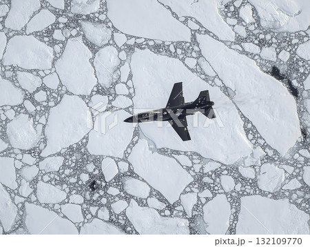 Aerial View Of A Jet Aircraft Over Fractured Icy Landscape In Monochrome 132109770