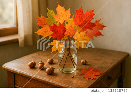 Autumn Maple Leaves in Glass Vase on Wooden Table 132110755