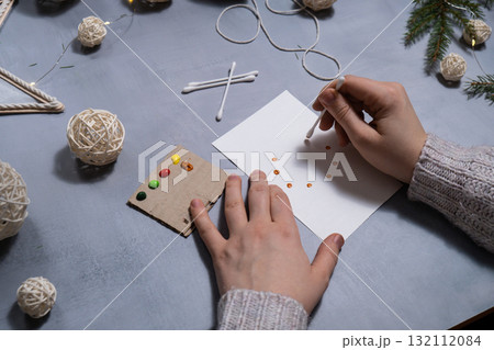 Christmas wreath Storytelling of creating craft Christmas greeting card holiday present. Tactile hand-on activity. Master class progress of creative me-made gifts. Seasonal domestic life micro moment 132112084