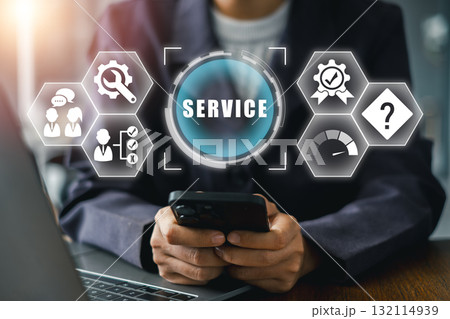 Businessperson using smartphone with digital service icons, symbolizing customer support and quality assurance. 132114939