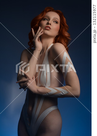 Beauty woman showcasing artistic body art in a studio setting 132115977