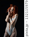 Beauty woman showcasing body art with tape and fur in studio setting 132115979