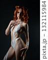 Woman showcases body art with tape and fur in a studio setting 132115984