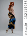 Stunning woman showcasing body art with fur in a studio setting 132115986