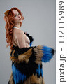 Creative body art and fur fashion presented by a model in a studio setting 132115989