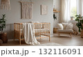 Minimalist nursery interior with wooden crib, cozy chair, and natural boho decor 132116091