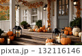 Cozy autumn porch decorated with pumpkins, candles, and orange leaves for seasonal celebration. The image represents fall atmosphere, warmth, and festive home decor 132116146
