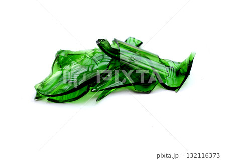 Sharp green glass shards scattered on a white background. Sharp green glass shards scattered on a white background. 132116373