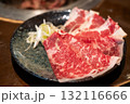 Sliced Negidare wagyu served on plate, a Wagyu beef with a soy based sauce made with green onions or scallions 132116666