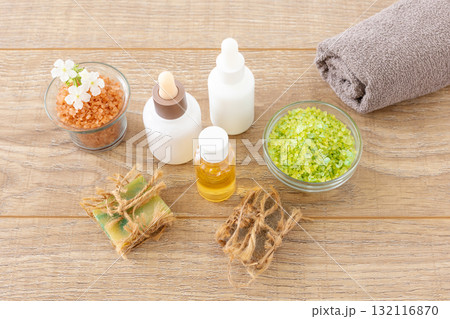 Body care products with a towel on the wooden background. Body care products with a towel on the wooden background. 132116870