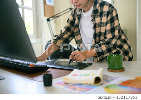 Cropped shot graphic designer working on creative desk computer while using graphic tablet at desk 132117853