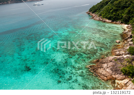 A beautiful rocky coastline meets clear turquoise waters in a tropical location on Redang Island in Malaysia. 132119172