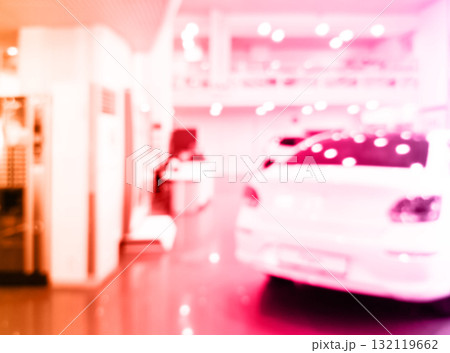 Blurred background with car dealership store interior. Blurred abstract dealership store with defocused cars. Blur bokeh transportation concept dealer showroom background Blurred background with car dealership store interior. Blurred abstract dealership store with defocused cars. Blur bokeh transportation concept dealer showroom background 132119662