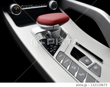 Automatic gear stick of a modern car. Modern car interior details. Close up view. Car inside. Automatic transmission lever shift. Black leather interior with stitching Automatic gear stick of a modern car. Modern car interior details. Close up view. Car inside. Automatic transmission lever shift. Black leather interior with stitching 132119673