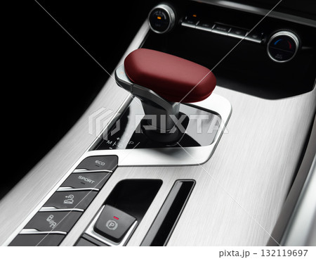 Automatic gear stick of a modern car. Modern car interior details. Close up view. Car inside. Automatic transmission lever shift. Black leather interior with stitching Automatic gear stick of a modern car. Modern car interior details. Close up view. Car inside. Automatic transmission lever shift. Black leather interior with stitching 132119697
