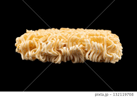 Texture of dry instant noodles isolated on black background. Raw dried Instant ramen noodles block isolated. Texture of dry instant noodles isolated on black background. Raw dried Instant ramen noodles block isolated. 132119708