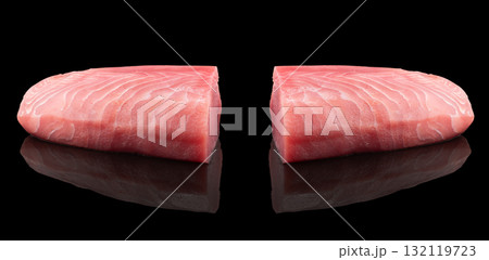 Yellow fin tuna steak isolated on black background. Fresh rare tuna steak isolated. Raw yellowfin tuna fillet texture. Background fresh fish meat. Top view of slices of tuna meat. 132119723