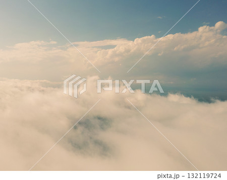 Aerial view White clouds in blue sky. Top. View from drone. Aerial bird's eye. Aerial top view cloudscape. Texture of clouds. View from above. Sunrise or sunset over clouds 132119724