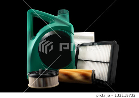 Car engine oil and filters isolated on black background. Car oil, air, fuel filters and motor oil in plastic can isolated. Quality spare parts for car service or maintenance Car engine oil and filters isolated on black background. Car oil, air, fuel filters and motor oil in plastic can isolated. Quality spare parts for car service or maintenance 132119732