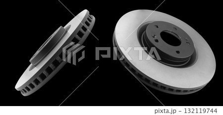 Car brake disc isolated on black background. Auto spare parts. Perforated brake disc rotor isolated on black. Braking ventilated discs. Quality spare parts for car service or maintenance. 132119744