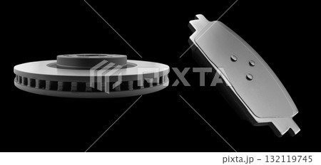 Car brake disc and brake pads isolated on black background. Auto spare parts. Perforated brake disc rotor isolated on black. Ventilated discs. Spare parts for car service or maintenance. Car brake disc and brake pads isolated on black background. Auto spare parts. Perforated brake disc rotor isolated on black. Ventilated discs. Spare parts for car service or maintenance. 132119745