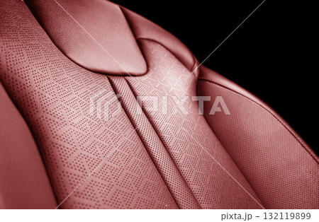 Car red leather interior. Part of red leather car seat details with white stitching. Interior of prestige car. Perforated leather seats isolated. Perforated leather. Car red leather interior. Part of red leather car seat details with white stitching. Interior of prestige car. Perforated leather seats isolated. Perforated leather. 132119899
