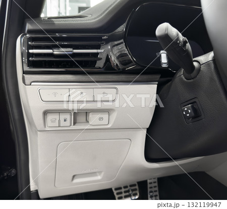Car wite leather interior. Part of wite leather car dashboard with white stitching. Interior of prestige car. 132119947