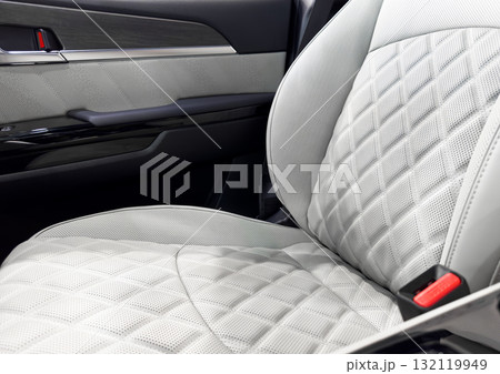 Car white leather interior. Part of white leather car seat details with white stitching. Interior of prestige car. Comfortable perforated leather seats. Perforated leather. 132119949