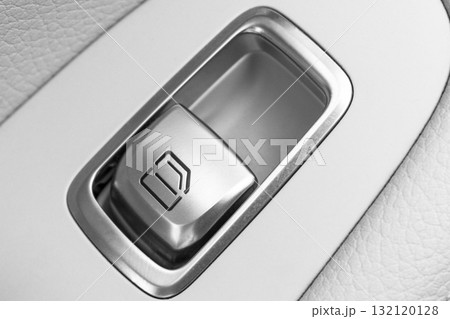 Car white leather interior details of door handle with windows control button. Car window controls of modern car. Car white leather interior details of door handle with windows control button. Car window controls of modern car. 132120128