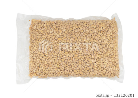 Cedar nuts in plastic bag isolated on white background. Transparent vacuum package of pine nuts. Top view, 132120201