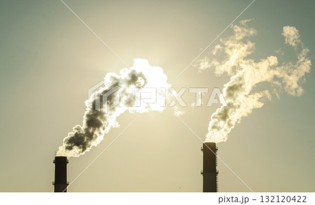 Factory with chimneys and Smoke. Bright Sun Shines Through Smoke Plant Power Plant. Industrial Background Factory with chimneys and Smoke. Bright Sun Shines Through Smoke Plant Power Plant. Industrial Background 132120422